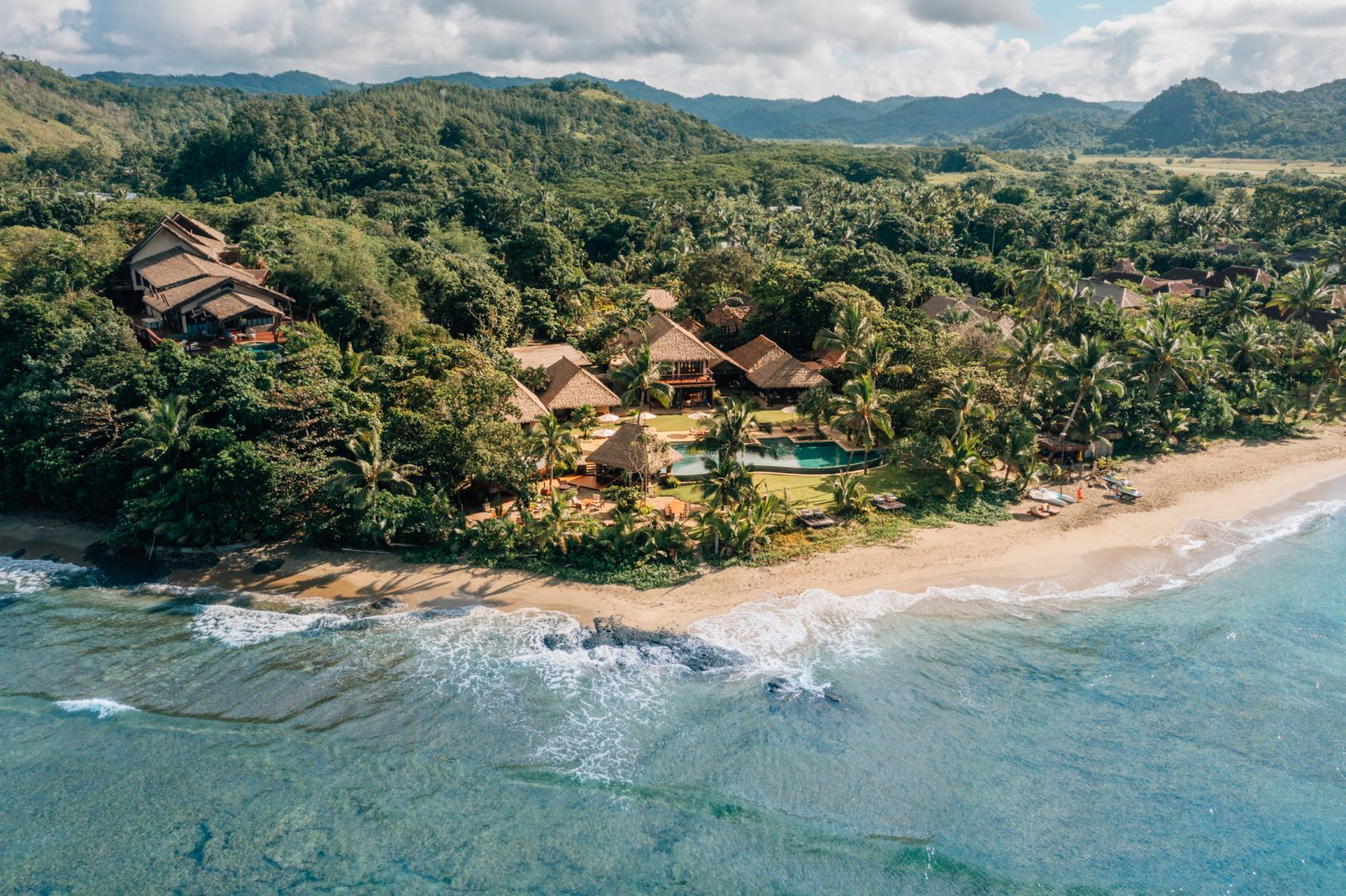 Aerial view of Nanuku Resort Fiji beachfront villas and pool